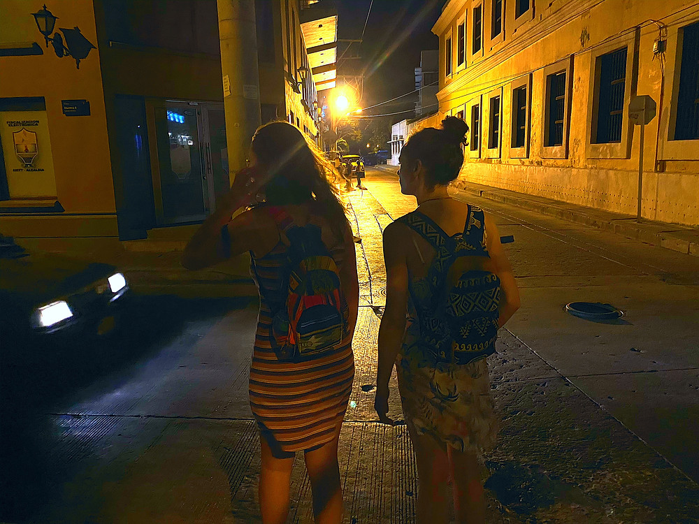Two in dresses girls walking at night in Colombia