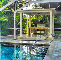 Outdoor kitchen with grill near pool; Kitchens and Pools