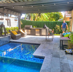 Outdoor kitchen with pool and man standing, Kitchens and Pools