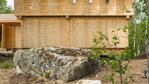 “Tømmertempelet,” or the "Timber Temple," is a mountain cabin in Sinnes, Norway, designed by Knut Folstad Arkitekt and completed in 2020. The project is a contemporary reinterpretation of traditional Norwegian cabin architecture, with the design blending traditional timber-framing methods with a modern, minimalist aesthetic. 

The design of Tømmertempelet is a playful response to the "artificially traditional" winter cabins that have become common in the area. The architect aimed to create a structure that felt both deeply rooted in local tradition and also difficult to place in a specific time or context. 
The cabin features a strong, solid pine timber structure that is exposed on the inside and outside, becoming the building's central aesthetic feature. The main volume is lifted off the ground on concrete spot foundations, which adapt to seasonal weather and the sloping landscape.

The cabin is clad with high-grade fir from a local sawmill, with an accordion-like panel on the second floor adding a dynamic element that interacts with light.
The interior features pine walls and spruce floors treated with hardwax oil, creating a warm and inviting atmosphere. Custom-built furniture in ash was also used.
Most of the cabin was built with locally sourced materials, and wood pulp was used for insulation.


The cabin is composed of two main volumes:
Main Volume: This area contains a double-height living room that opens to the outdoors, a kitchen, and a sleeping loft. A diagonal line cuts through the interior, making the space feel larger than its compact size.
Smaller Volume: This section contains the bathroom and toilet.

The cabin’s bathroom contains a custom, rich-green aluminum sitting tub, which, according to the architect, suggests a small forest pond when filled with water.
The placement of the high windows allows morning and evening light to dramatically enter the space, creating a sense of natural tranquility. 


Credits 

Architect: Knut Folstad Arkitekt 

Lead Architect: Knut Folstad 

Contractor: Kjernebygg  

Photography: Knut Folstad   