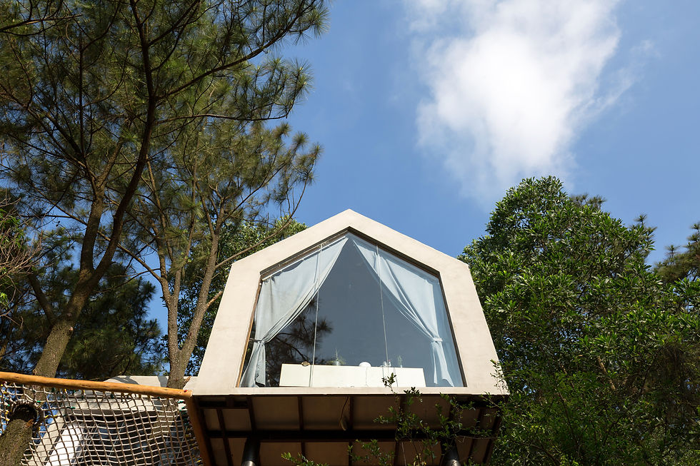 Forest House 02 is a minimalist and lightweight tiny home designed by Chu Van Dong of D12 Architect. Completed in 2018, the 45 m² house is located in the northern mountains of Vietnam, near Hanoi, and was created to serve as a serene retreat for 2–4 people. The house is notable for its innovative, treehouse-inspired design, which perches it on a steep hill and uses a playful "hammock deck" to integrate the living space with a large, existing tree trunk.
The design of Forest House 02 prioritizes a minimal impact on the natural surroundings and an intimate connection with the environment. The house is built with a simple, lightweight structure using steel box frames, wood, glass, lightweight concrete, and clay stone. This approach reduces the load on the foundation and minimizes the construction's effect on the landscape. The house is supported by two steel pillars and rests on a rock drop-off, making it feel like it is floating among the treetops.
The interior, at nearly 500 square feet, is arranged in an L-shape, accommodating a combined living room-kitchen area and a bedroom. Floor-to-ceiling glass windows and sliding doors liberate the views and maximize the interaction between the interior and the forest.
Forest House 02 is distinguished by its material choices and unique features that blend comfort with the outdoors. A favorite feature is the "hammock-like" terrace, an outdoor playground with a net deck that wraps around a large tree trunk, offering a relaxing, semi-suspended space among the branches.
The predominantly wooden interior is accented with stone and marble, creating a "luxe glamping" feel that is both rustic and elegant. As with Chu Van Dong's earlier work, the project demonstrates a commitment to creating low-cost yet well-designed residential spaces.
Project credits
Architect: D12 Architect
Lead Architect: Chu Van Dong
Location: Sóc Sơn District, Hanoi, Vietnam
Completion Year: 2018
Photographer: Lê Hoàng
Manufacturers: Dulux, Hoa Phat (materials), and local pine wood