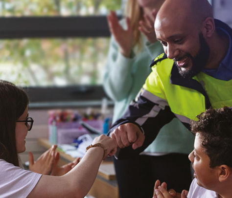 Policeman interacting with students