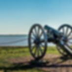 civil war cannon facing water in the sun