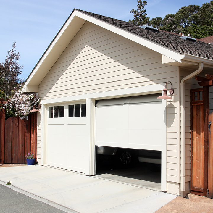 Two door garage with one door slightly raised making it a perfect target for burglars