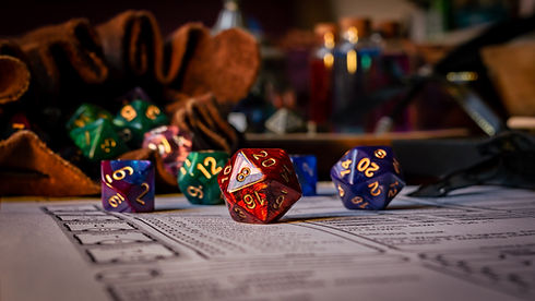 Close up of spilling out dice of different kinds from a dice bag on a character sheet.jpg