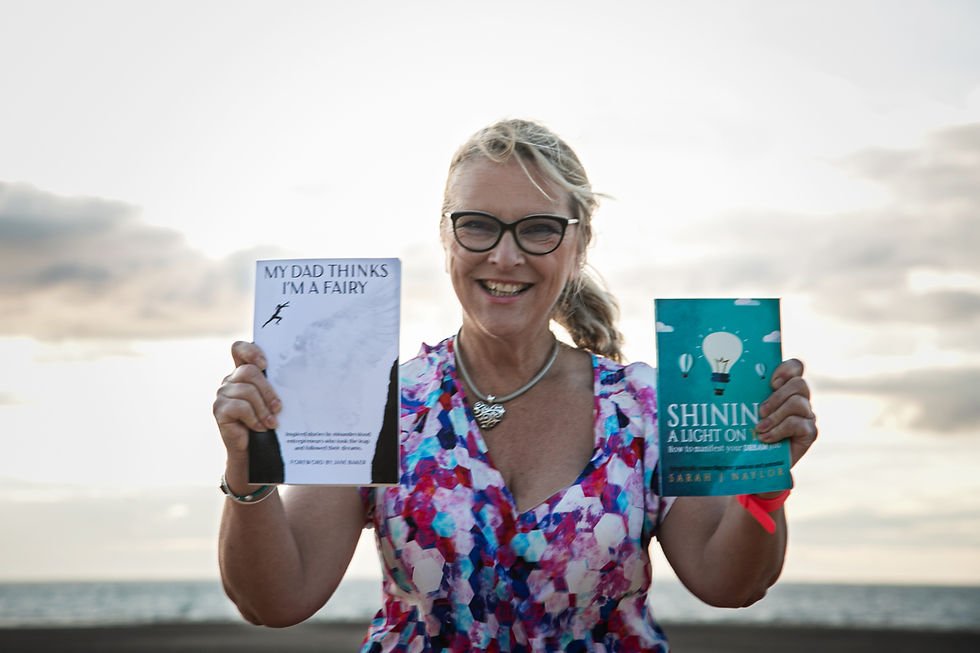 Sarah J Naylor holding "My Toad Thinks I'm a Fairy" and "Shining a Light On" books
