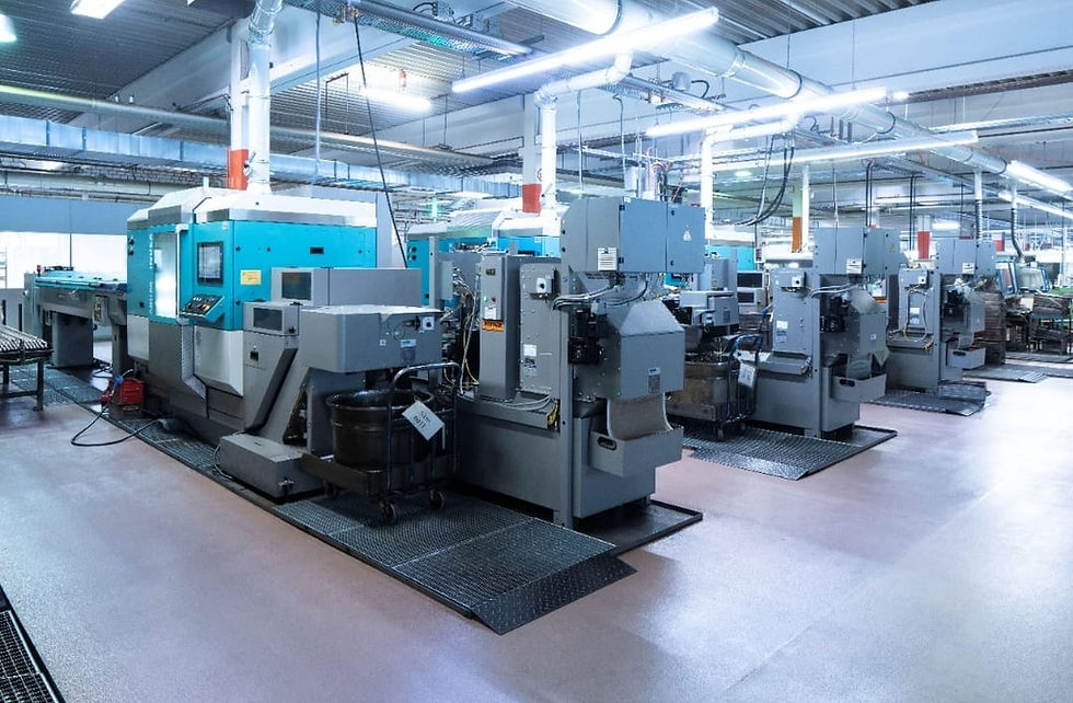 Row of industrial machinery in a modern factory facility.