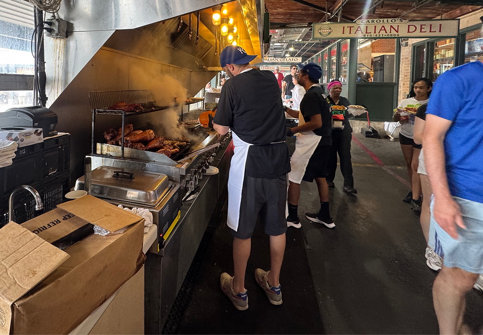 BBQ vendor grilling smoked meats at City Market in Kansas City, Missouri, near Carollo's Italian Deli