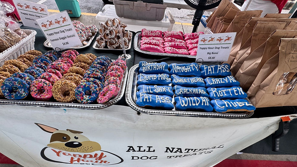Colorful Yappy Hour Dog Treats including doggie donuts and large bone-shaped biscuits on display at City Market in Kansas City, Missouri