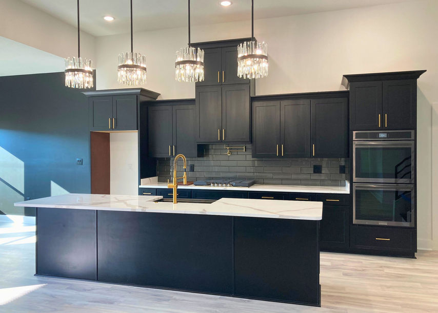 Regal black shaker cabinets and island with modern light fixtures above