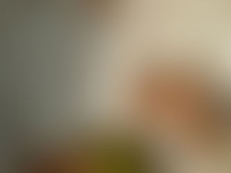 femme en chemise blanche qui tient un verre de jus de légumes entre les mains avec une paille en acier