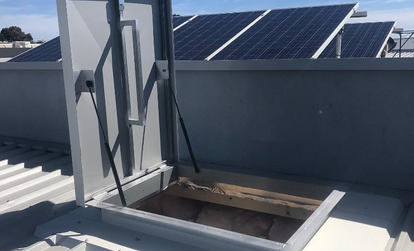 Sturdy roof access hatch on a metal rooftop, providing safe and easy maintenance access. M