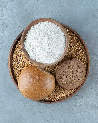 rye-bun-with-bowl-flour-wooden-plate copia 2.webp
