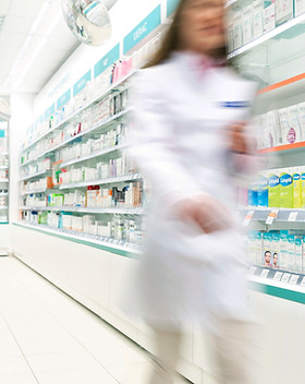 Pharmacist in aisle of Pharmacy