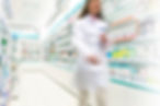 Pharmacist in aisle of Pharmacy