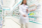 Pharmacist in aisle of Pharmacy