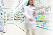 Pharmacist in aisle of Pharmacy