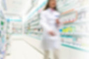 Pharmacist in aisle of Pharmacy