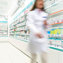 Pharmacist in aisle of Pharmacy