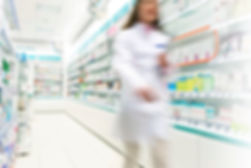 Pharmacist in aisle of Pharmacy