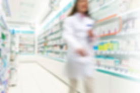 Pharmacist in aisle of Pharmacy