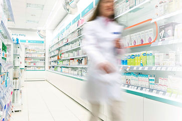 Pharmacist in aisle of Pharmacy