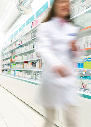 Pharmacist in aisle of Pharmacy