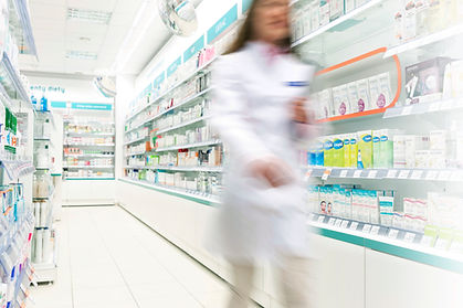 Pharmacist in aisle of Pharmacy