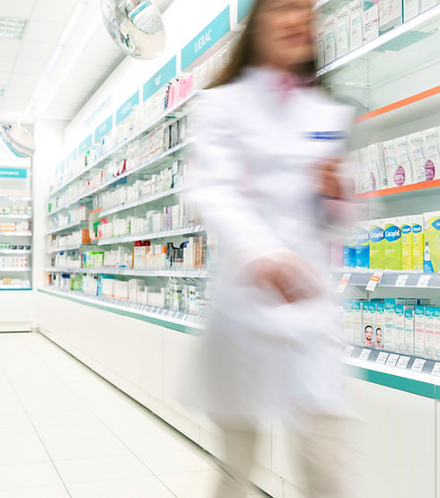 Pharmacist in aisle of Pharmacy