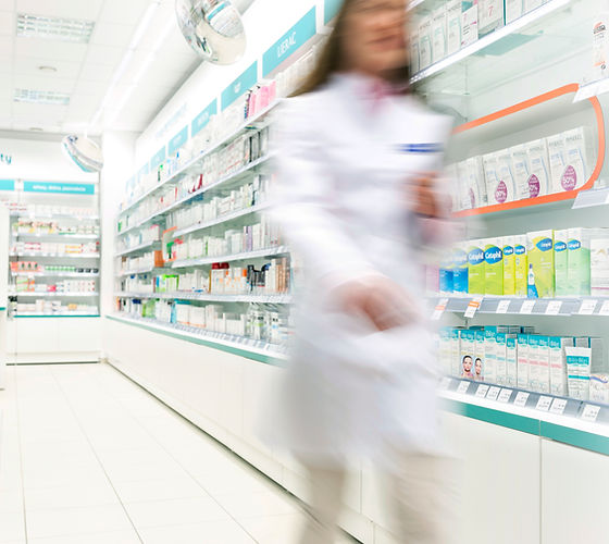 Pharmacist in aisle of Pharmacy