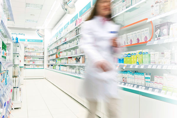 Pharmacist in aisle of Pharmacy