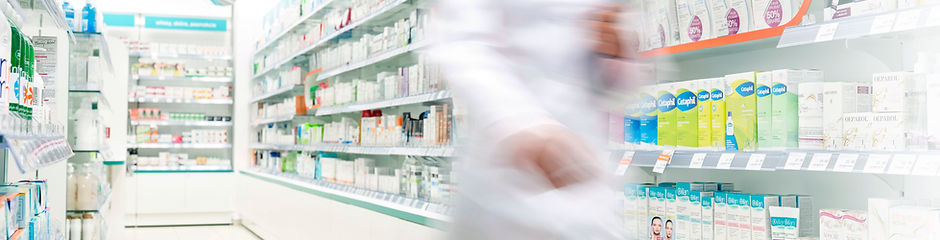 Pharmacist  in aisle of Pharmacy