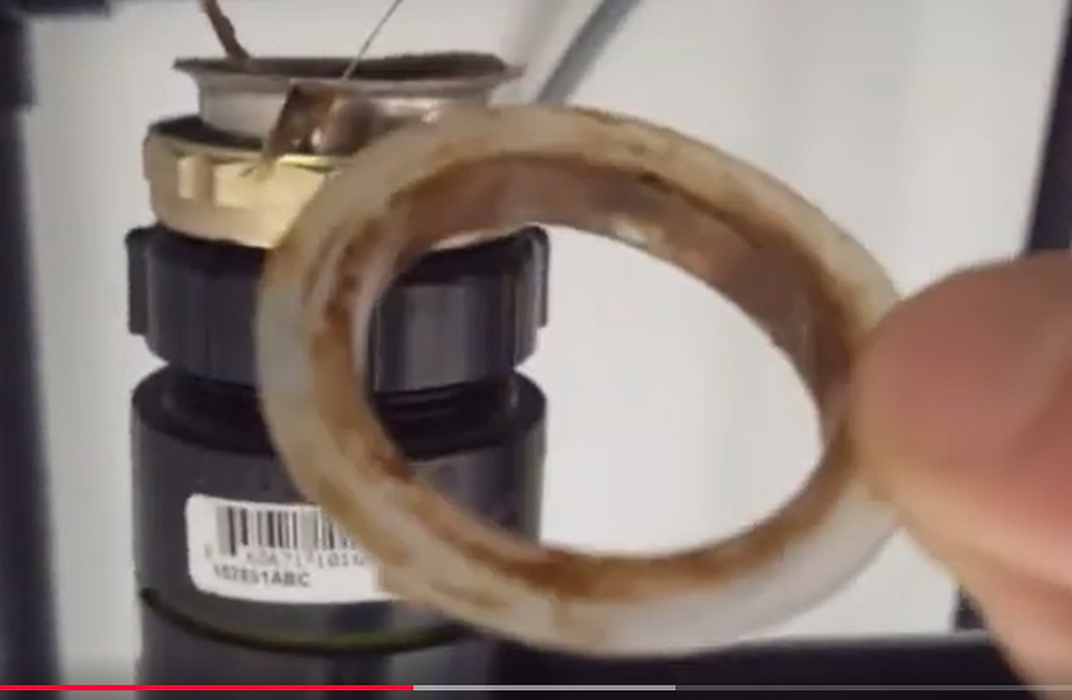 Replacing worn T washer gasket under kitchen sink drain
