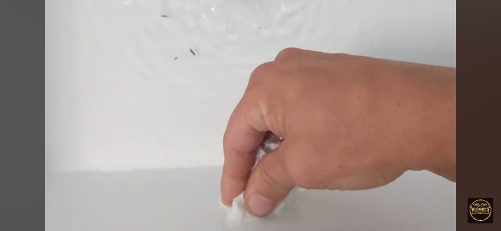 Toilet plunger creating a seal on a bathroom sink drain to clear a blockage
