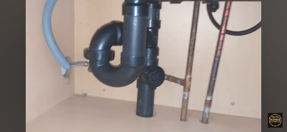 Double kitchen sink drain assembly showing P-trap, tee fitting, and AAV connection