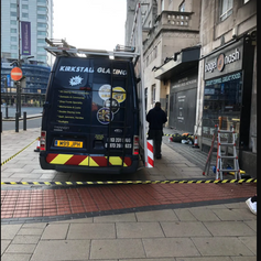 A business van that is parked on the street.png