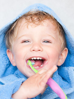 Toddler with tooth brush promoting Portwall Dental Care Plan
