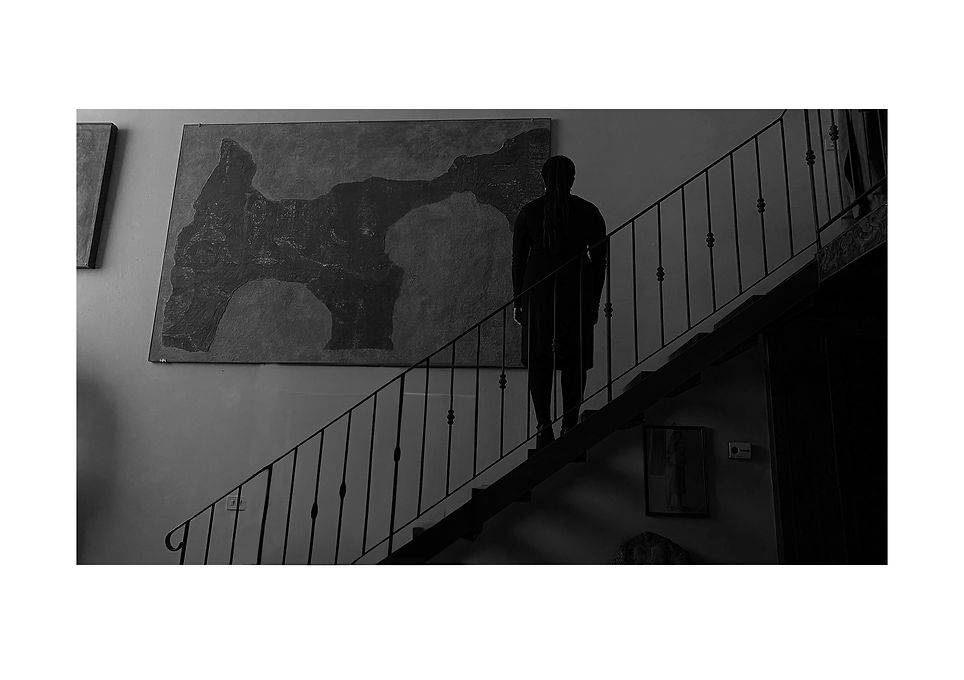 woman on stairs looking at wall