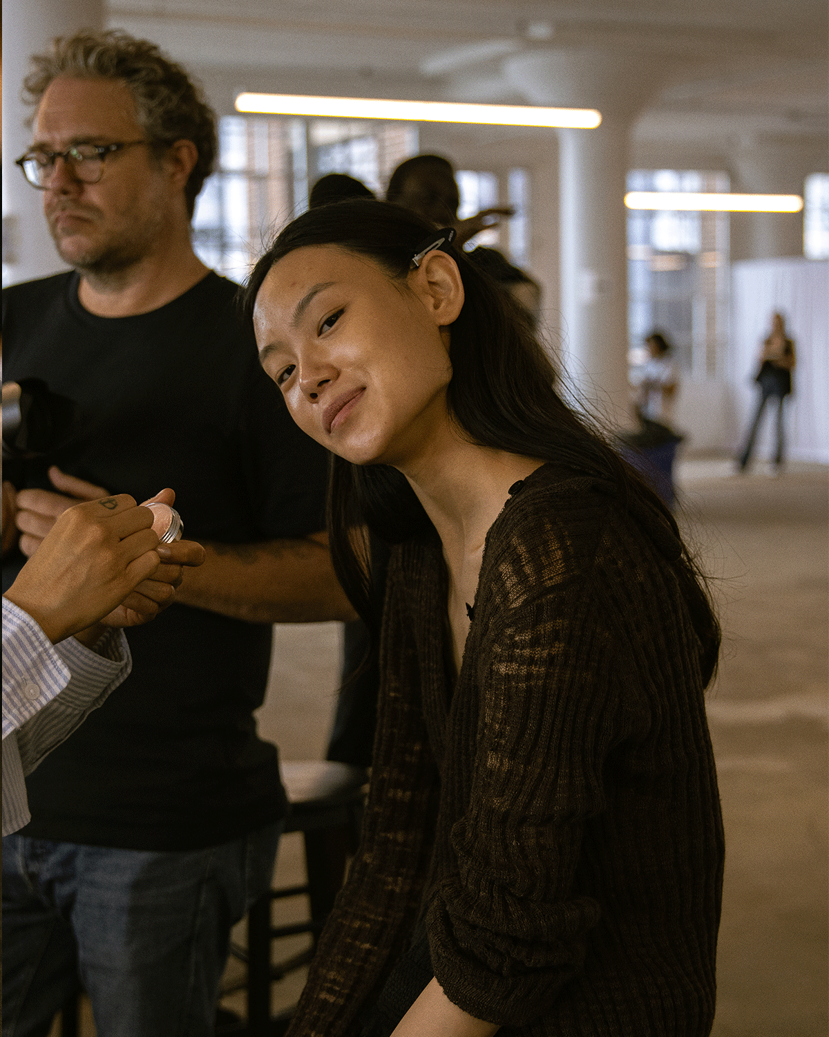 model posing for the camera in makeup chair 