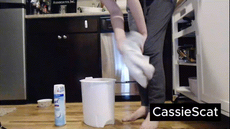 Woman shitting on a bucket
