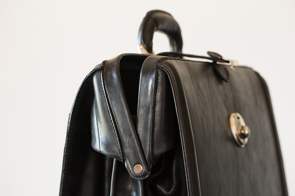 Close-up of custom black leather attorney briefcase and lock.