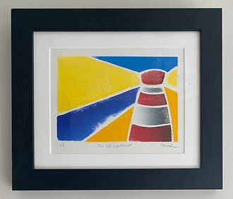 A linocut in a white mount and black frame. A white-line linocut of a lighthouse on a beach, shining its light out to sea. The linocut is built up of spaces of colour with white lines left between them. The minimalist Lighthouse is striped red and white. The beach is represented as a warm yellow area with a dark blue sea to the left, a slightly lighter blue sky above and a bright yellow light shining out to the left and right from the lighthouse.