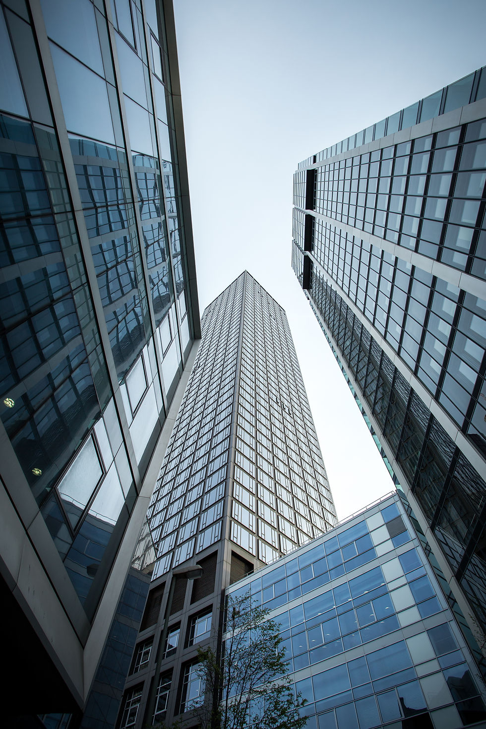 vertical-low-angle-shot-high-rise-skyscrapers-glass-facade-frankfurt-germany.jpg