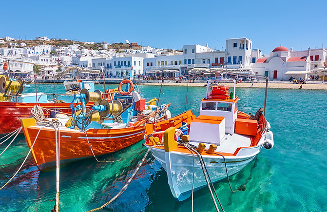 Harbour with wooden fishing boats in the harbour on sunny day, Mykonos, Greece.