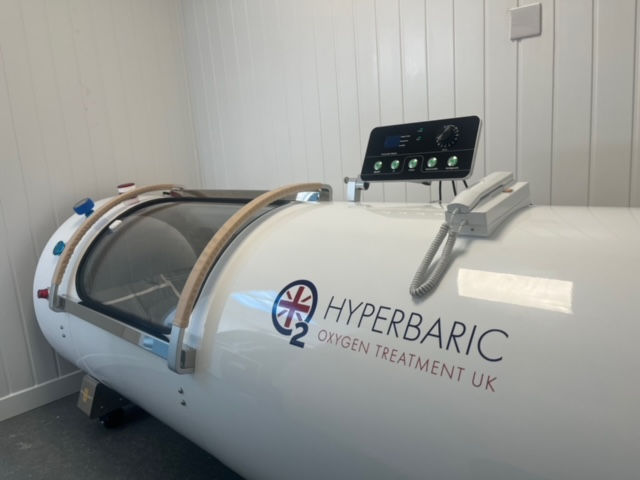 Front view of 2.5 ATA black hyperbaric oxygen chamber with sliding door