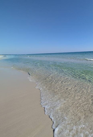 Beautiful Navarre Beach near The Peach & Palm, sugar-white sand, emerald water, and peaceful shoreline just steps away