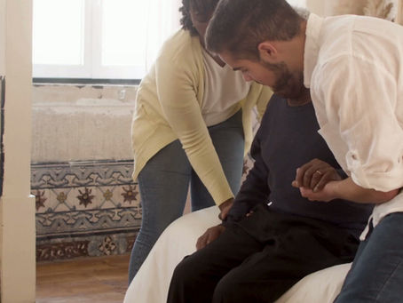 People are taking care of an elderly man in a Care home enviroment 