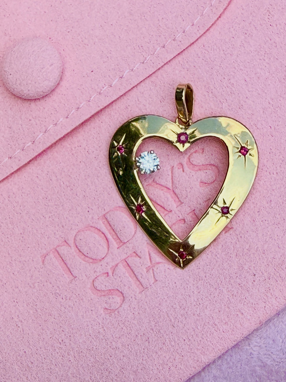 Thumbnail: Vintage 14k ruby and floating diamond heart pendant photographed on pink velvet box
