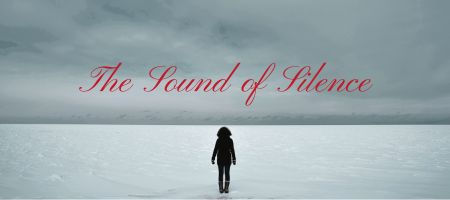 A woman standing alone in a sea of snow.