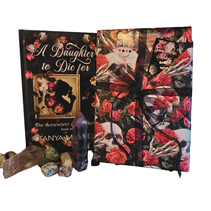 The book A Daughter to Die For next to a book wrapped in decorative paper as a mystery book